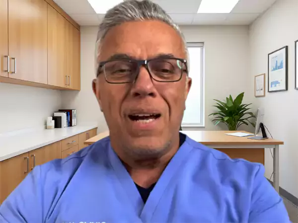 Karl in consulting room explaining why clients choose arya clinic